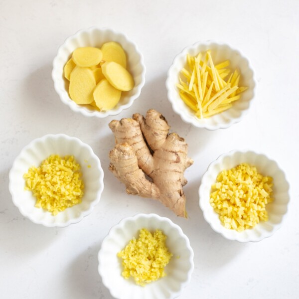 fresh Ginger root cut in 5 ways in small bowls - slice, chop, mince, julienne, grate