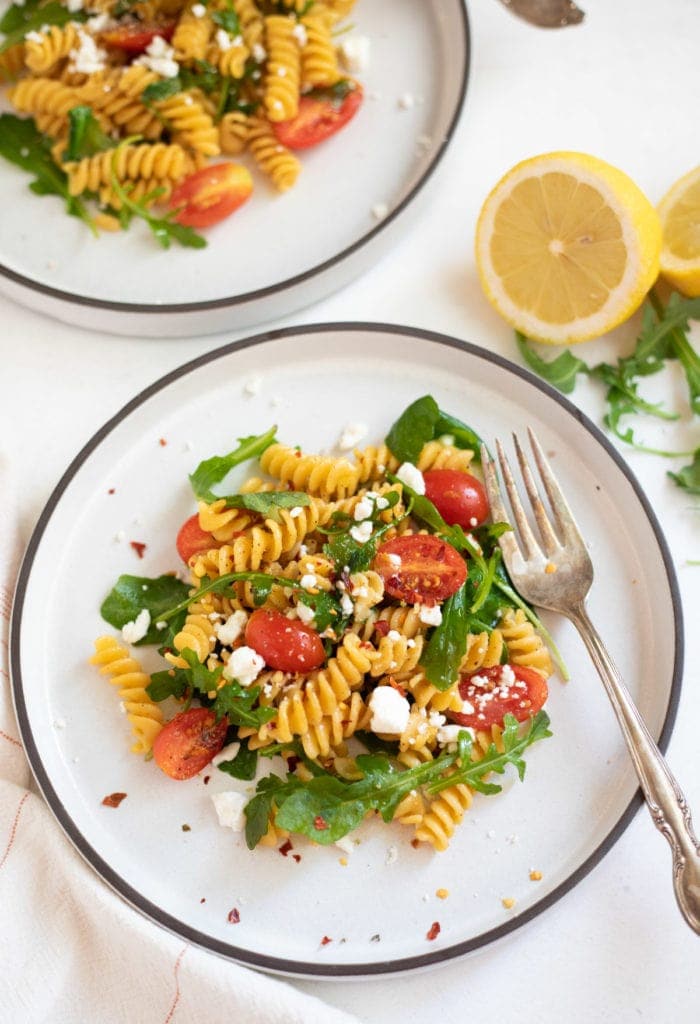 Rotini Chickpea Pasta with Arugula and cherry tomatoes topped with feta cheese