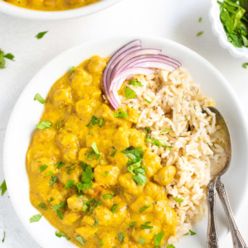Chickpea Curry with coconut milk served over rice garnished with cilantro