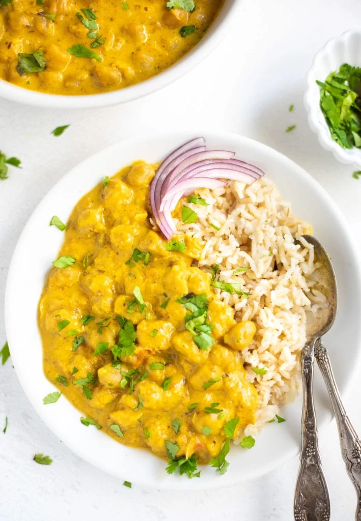 Chickpea Curry with coconut milk served over rice garnished with cilantro
