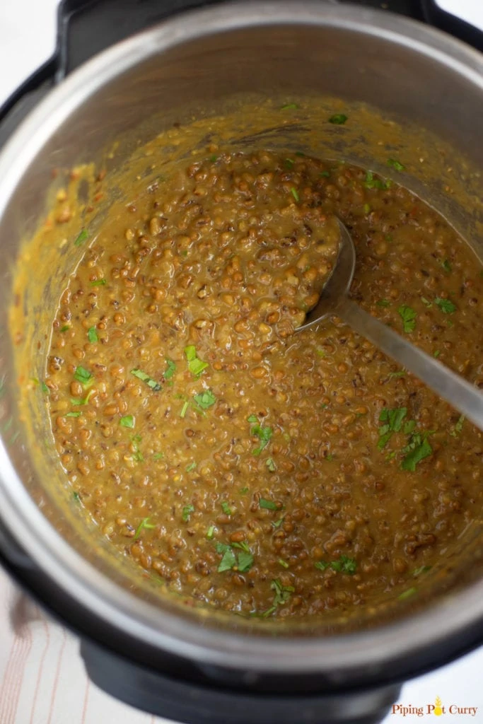 cooked Moth lentils in the instant pot garnished with cilantro 