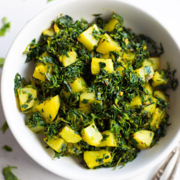 Methi aloo in a white bowl