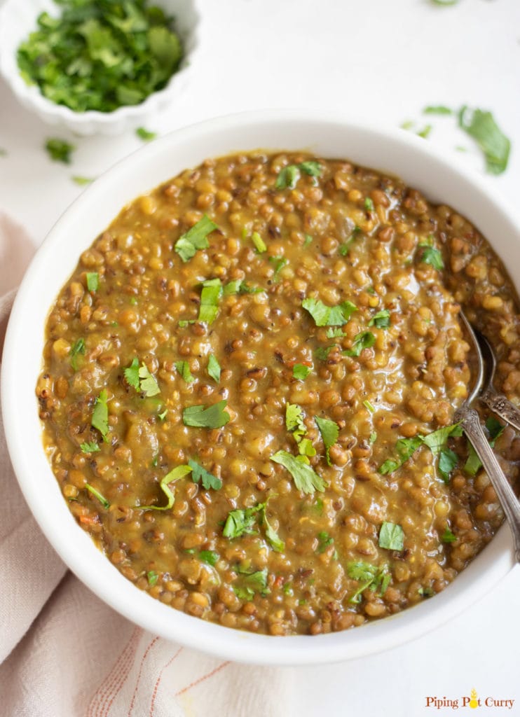 Moth beans dal in a bowl garnished with cilantro