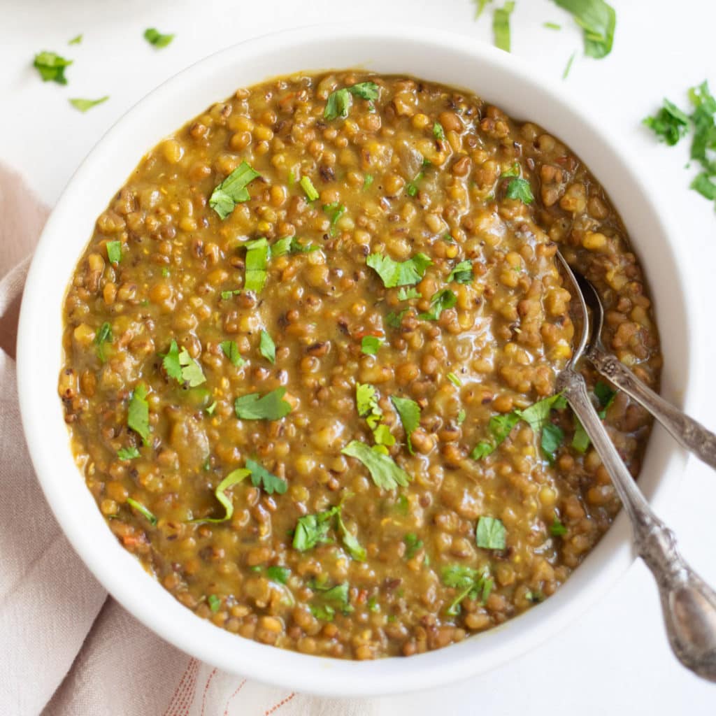 Moth beans dal in a bowl garnished with cilantro