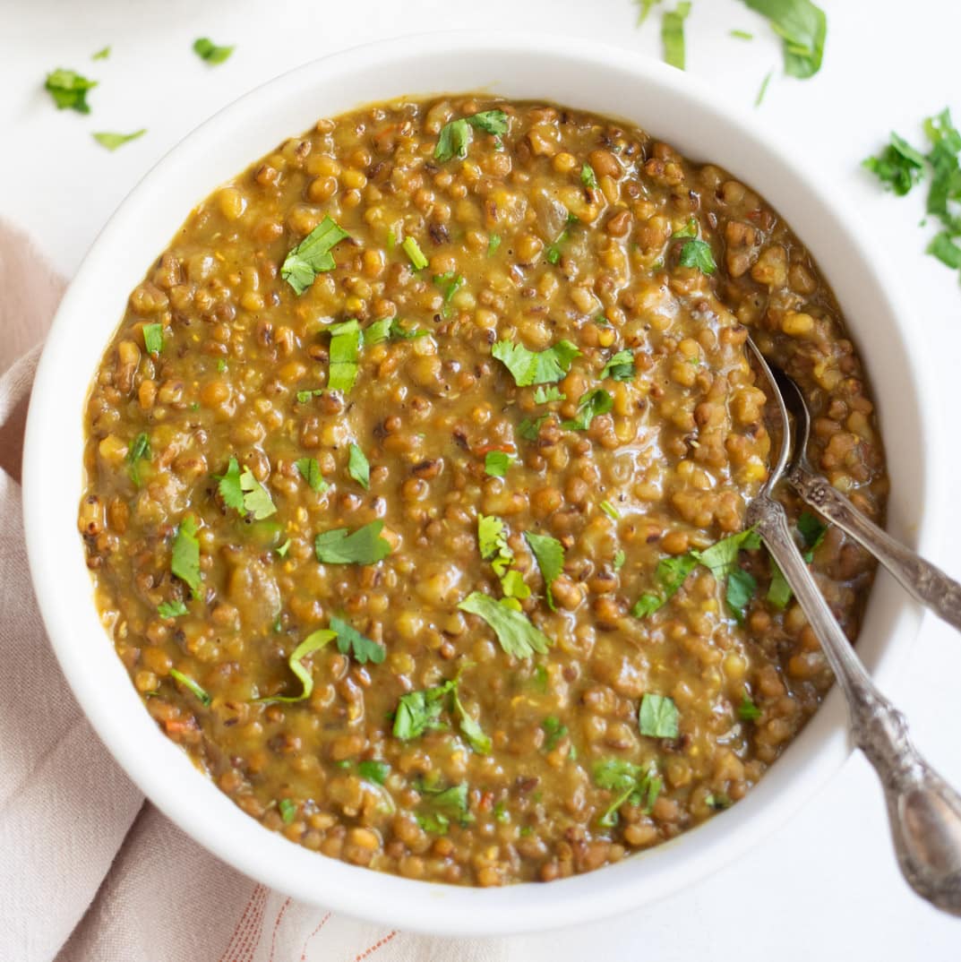 Moth beans dal in a bowl garnished with cilantro