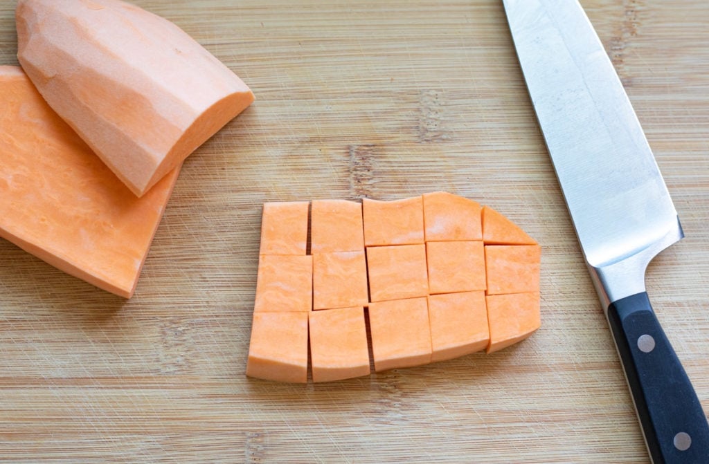 sliced sweet potatoes in a chopping board with silver knife