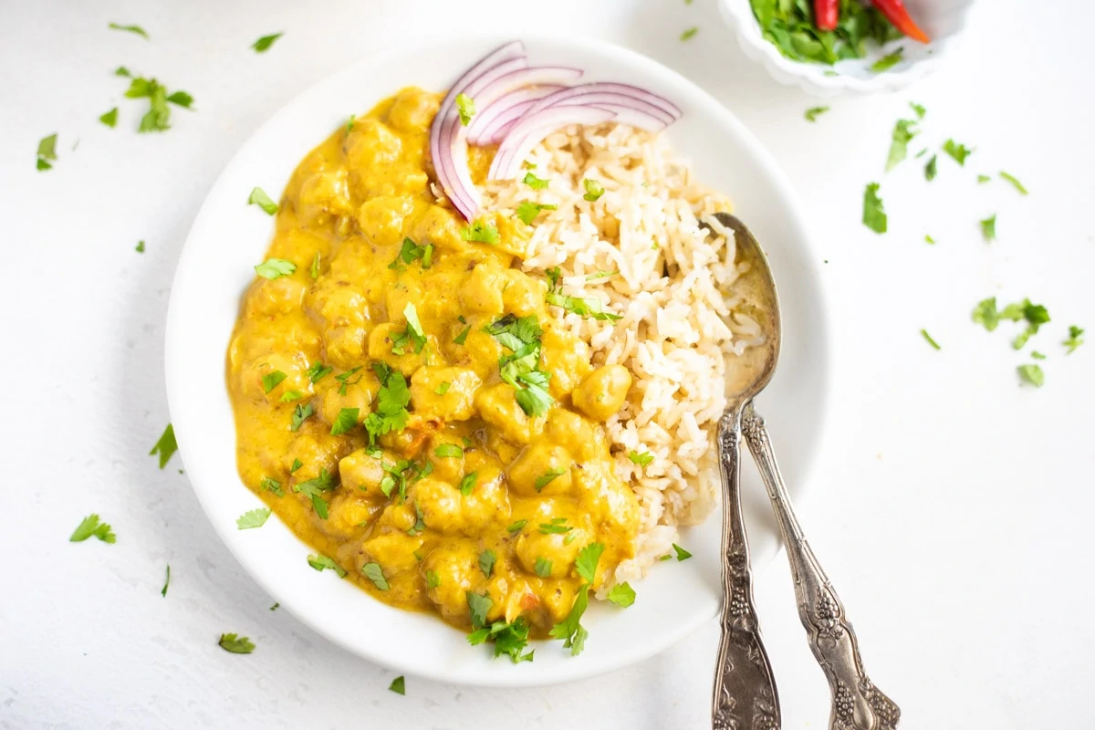 Chickpea Curry with coconut milk served over rice garnished with cilantro
