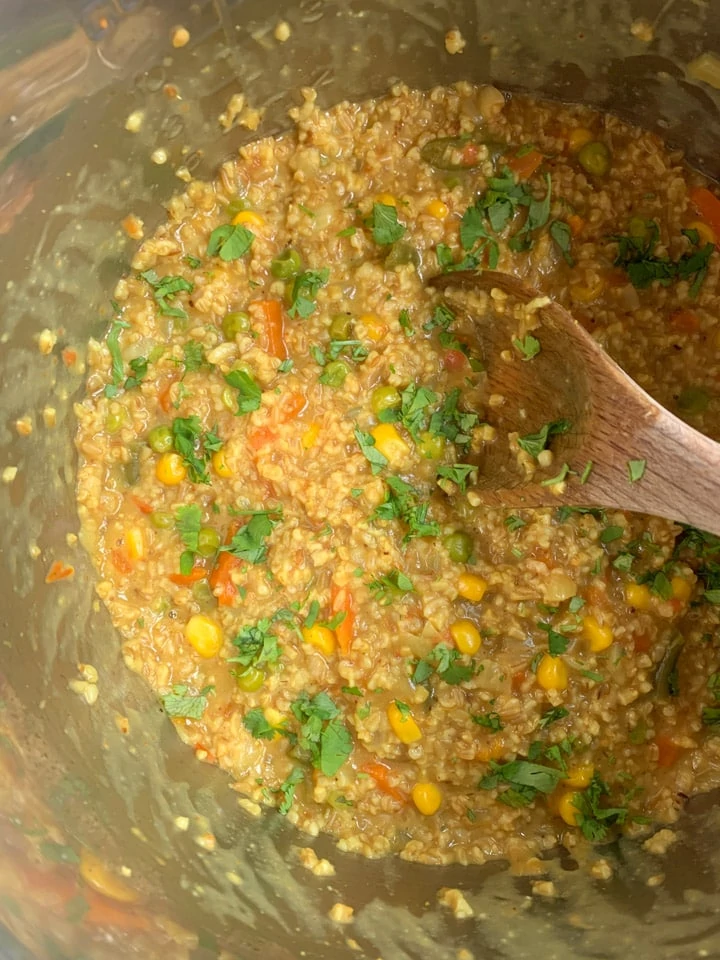 Curried Masala oatmeal cooked in the instant pot garnished with cilantro