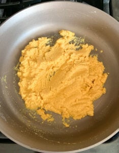 Besan with ghee in a pan