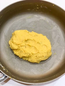 smoothing besan mixture in the pan