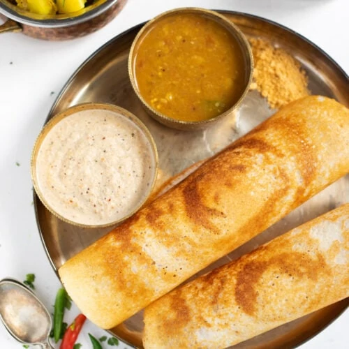 Crispy Dosa with chutney and sambar in a plate