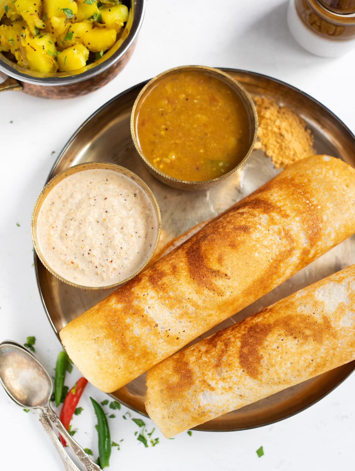 Crispy Dosa with chutney and sambar in a plate