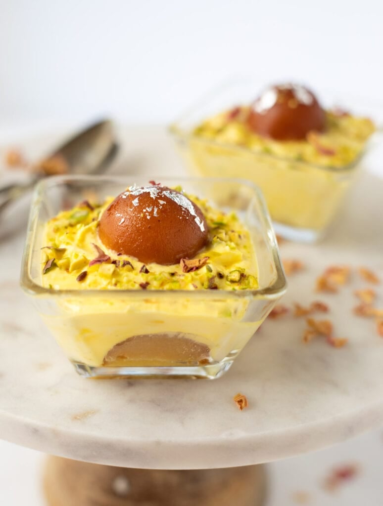 Gulab jamun and shrikhand layered in bowls to make a pretty indian dessert