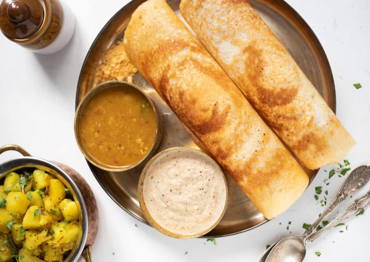 Dosa with chutney and chutney, and potato masala on the side