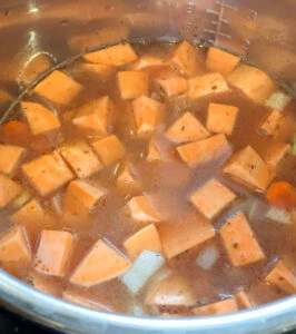 All ingredients in the pressure cooker for sweet potato soup