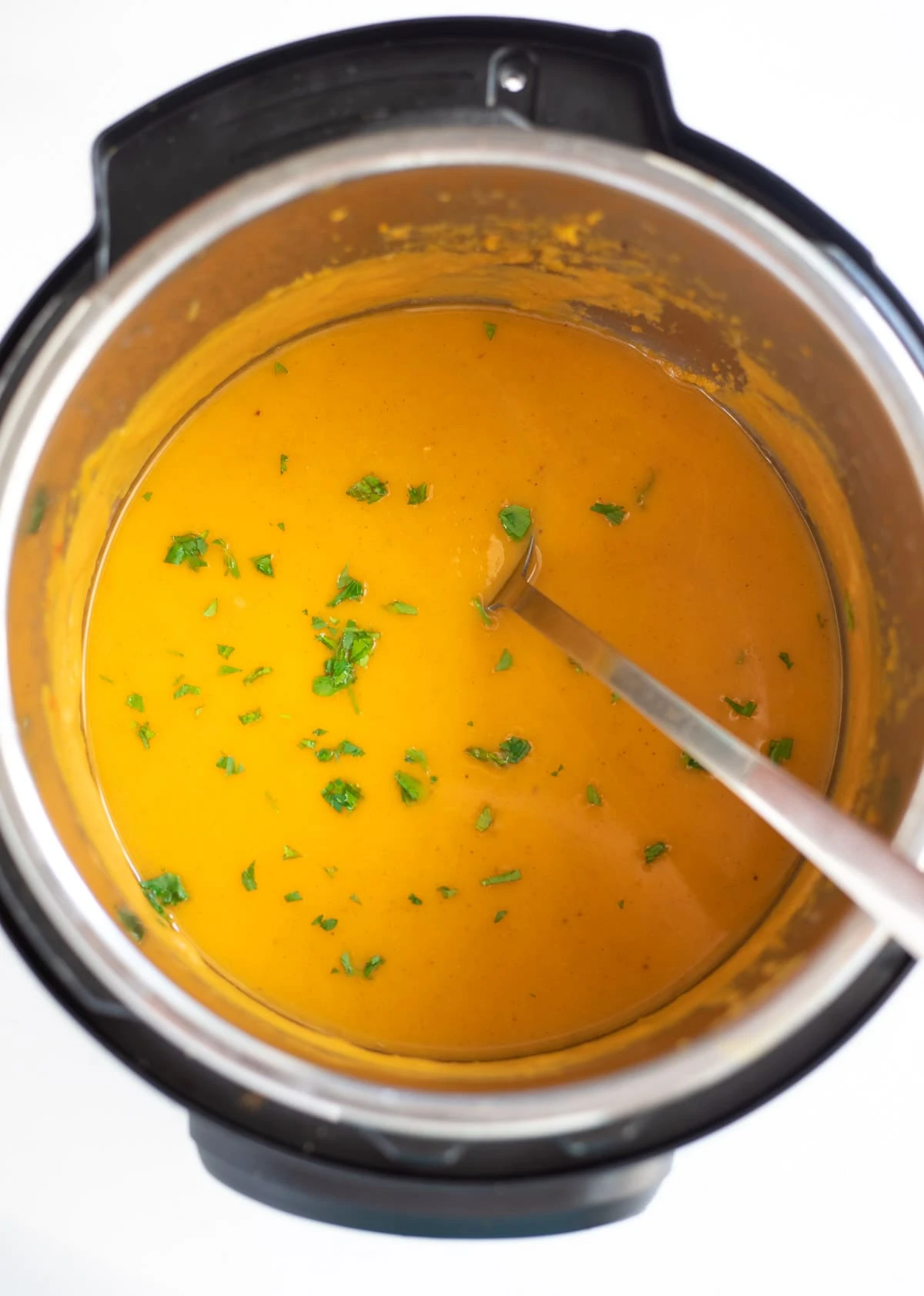Creamy Sweet Potato Bisque in the instant pot garnished with parsley 
