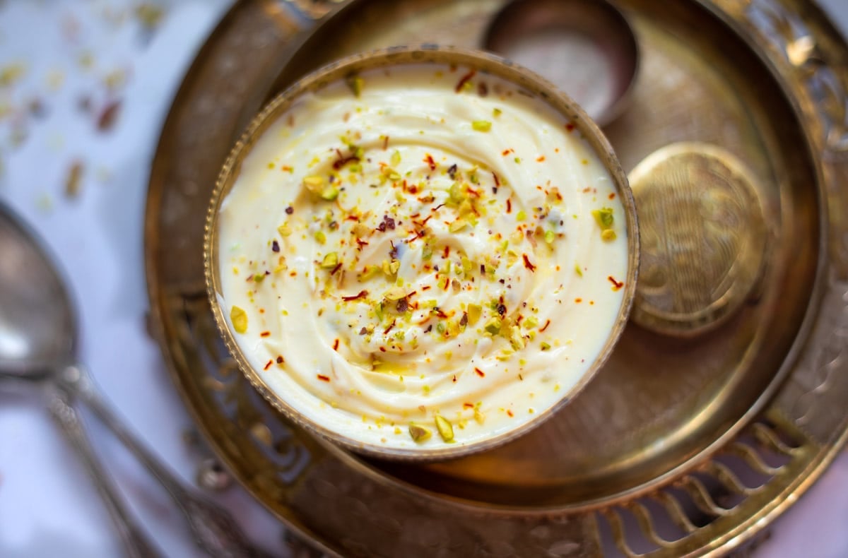 Indian Shrikhand in a pretty bowl on a festive bronze plate