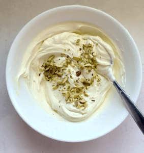 creamy hung yogurt in a bowl with pistachios on top