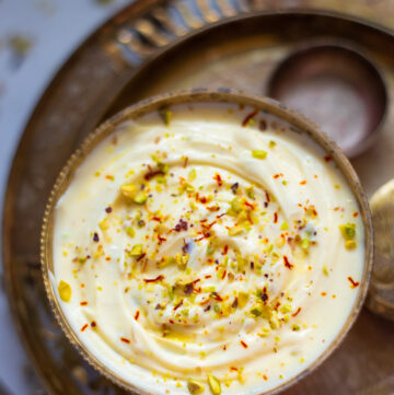 Shrikhand in a pretty bowl garnished with saffron and pistachios - Kesar Pista shrikhand