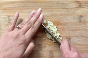 mincing garlic using a knife