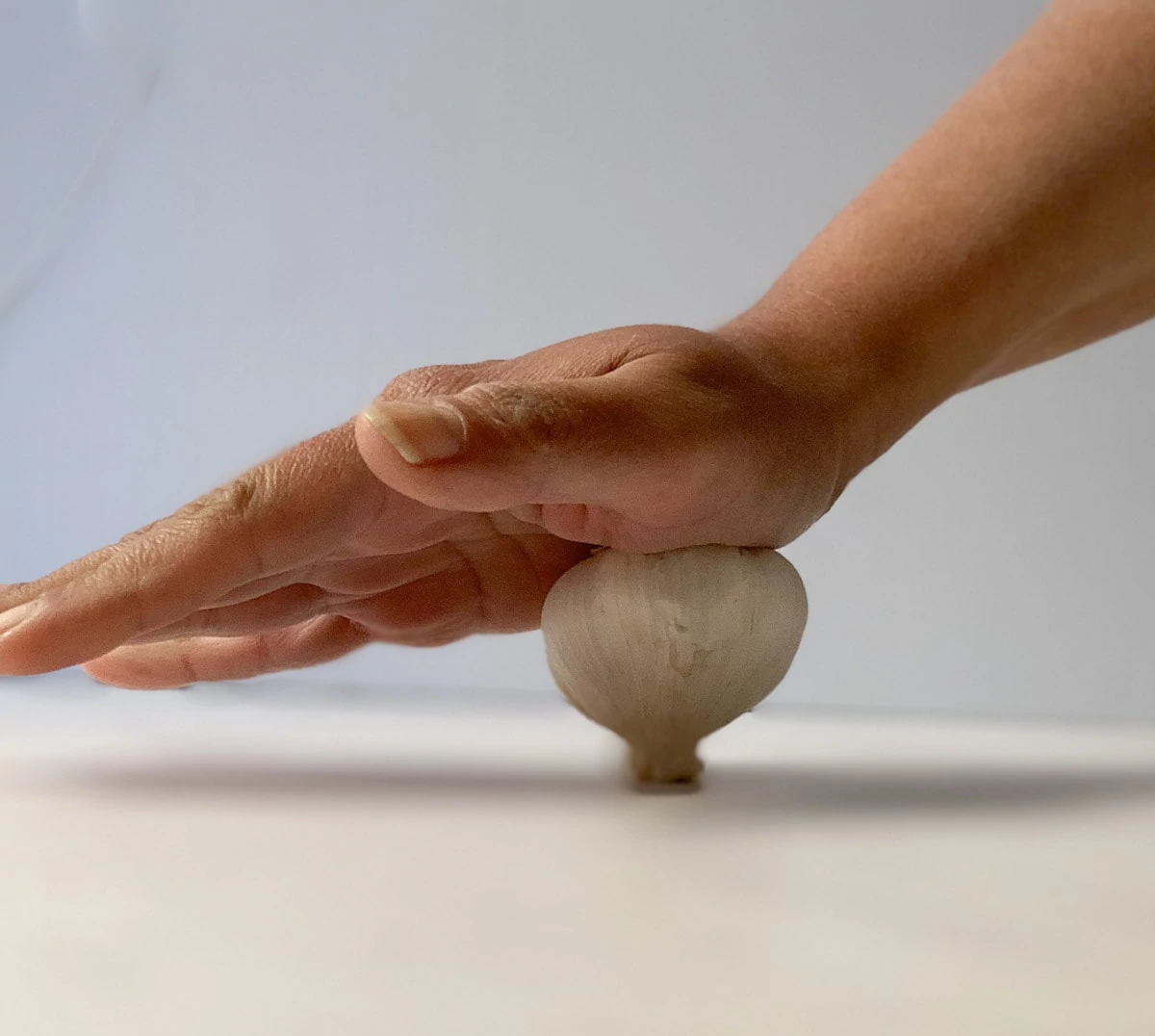 Press the Garlic bulb with palm to loosen the cloves