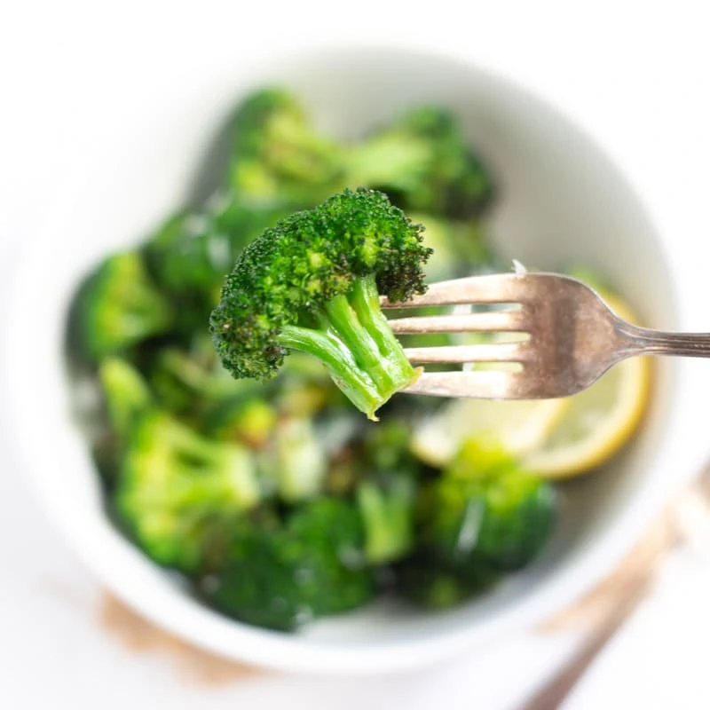 Closeup of roasted broccoli in a fork