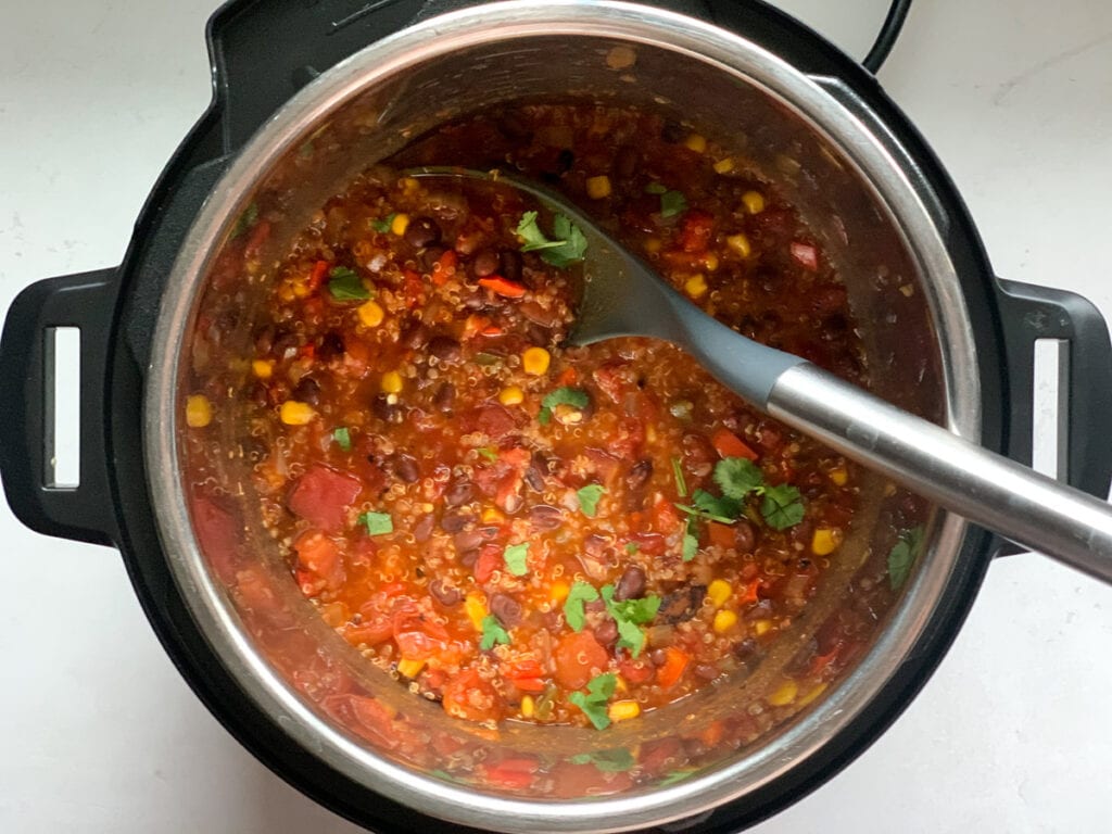 Vegetarian Chili with corn, black beans, quinoa and bell peppers in the pressure cooker