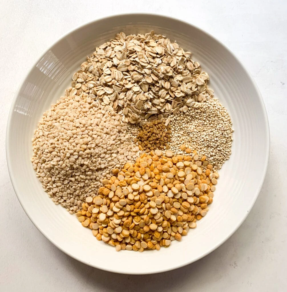 Quinoa, Urad Dal, Chana Dal, rolled oats and methi seeds in a bowl
