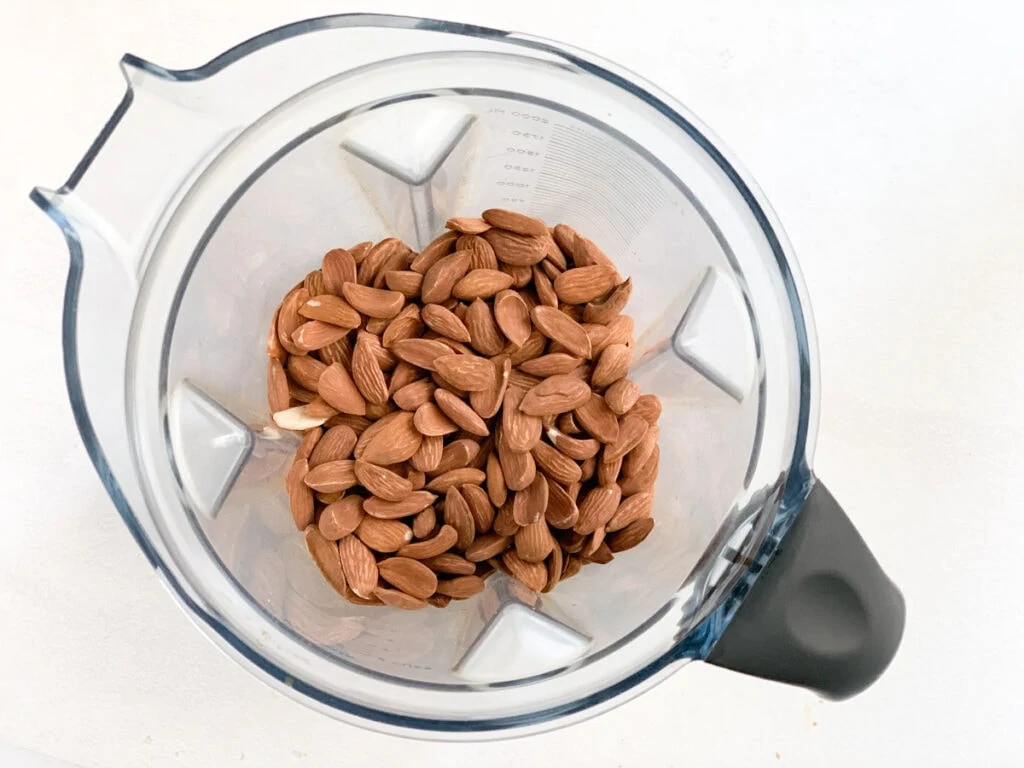 overhead shot of roasted almonds in a vitmix blender