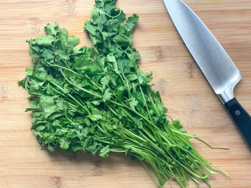 Fresh coriander leaves on a cutting board