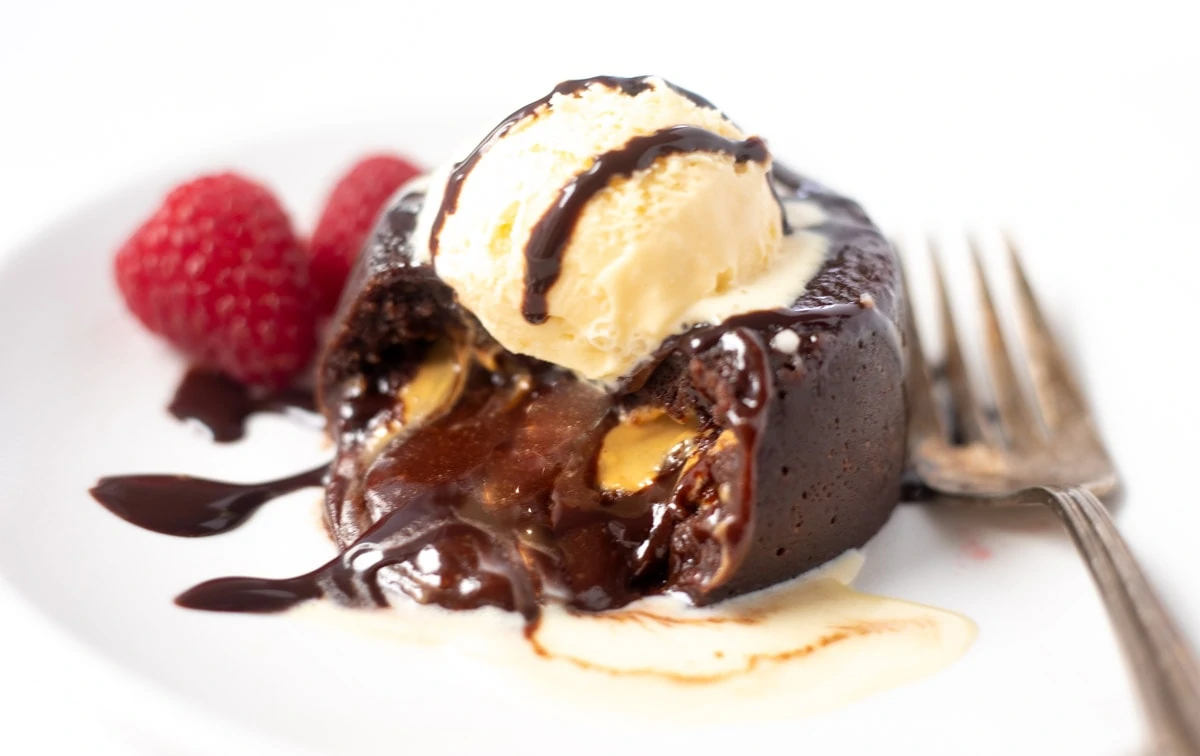 Molten Chocolate Lava cake with molten chocolate flowing out topped with ice-cream