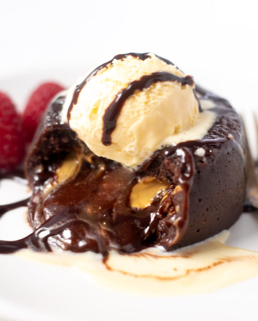 Chocolate Lava cake with molten chocolate flowing out topped with ice-cream