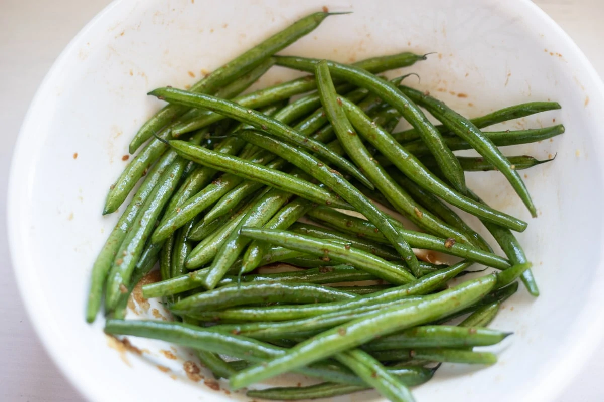 Seasoned green beans in a white bowl