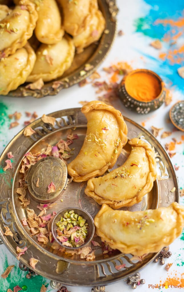 Mawa Gujiya served in a plate decorated for Holi