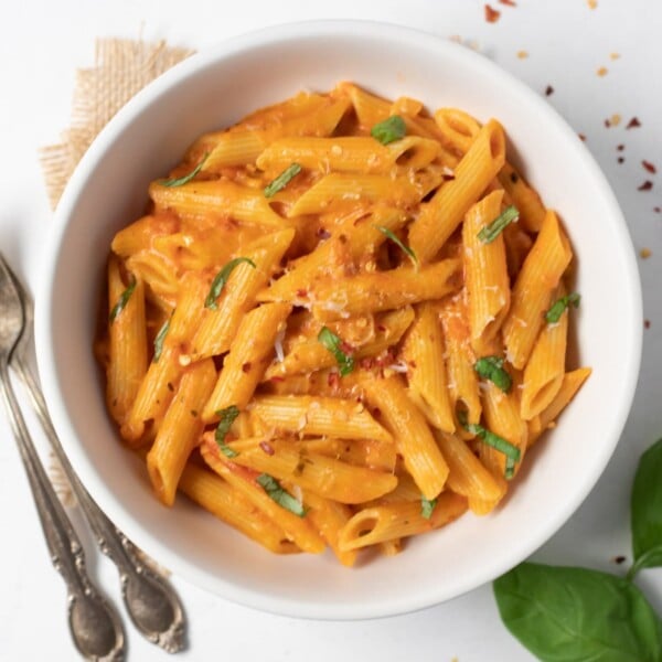 Creamy Penne Pasta topped with basil, parmesan and chili flakes