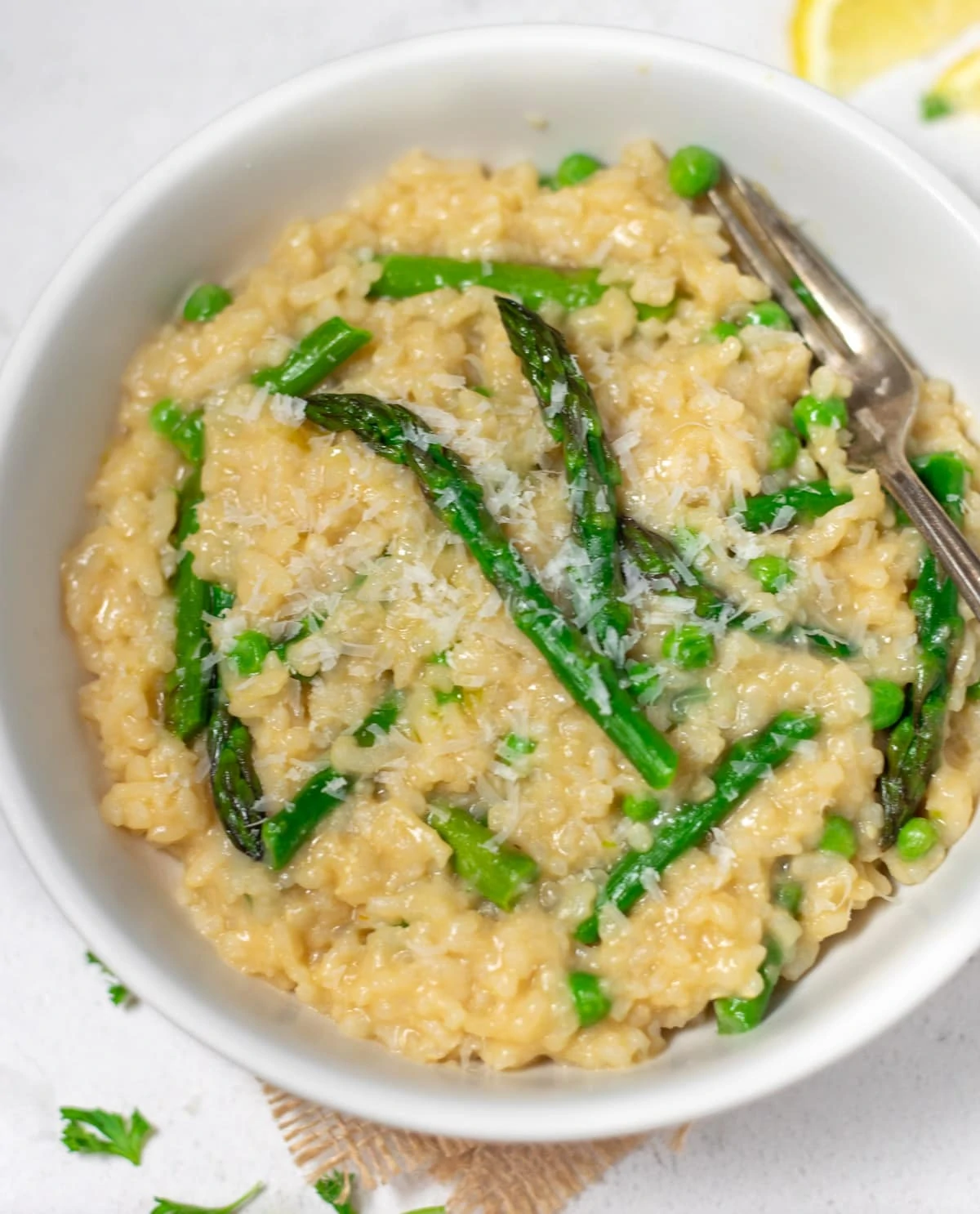 Creamy Spring Asparagus Risotto in a bowl topped with crunchy asparagus 