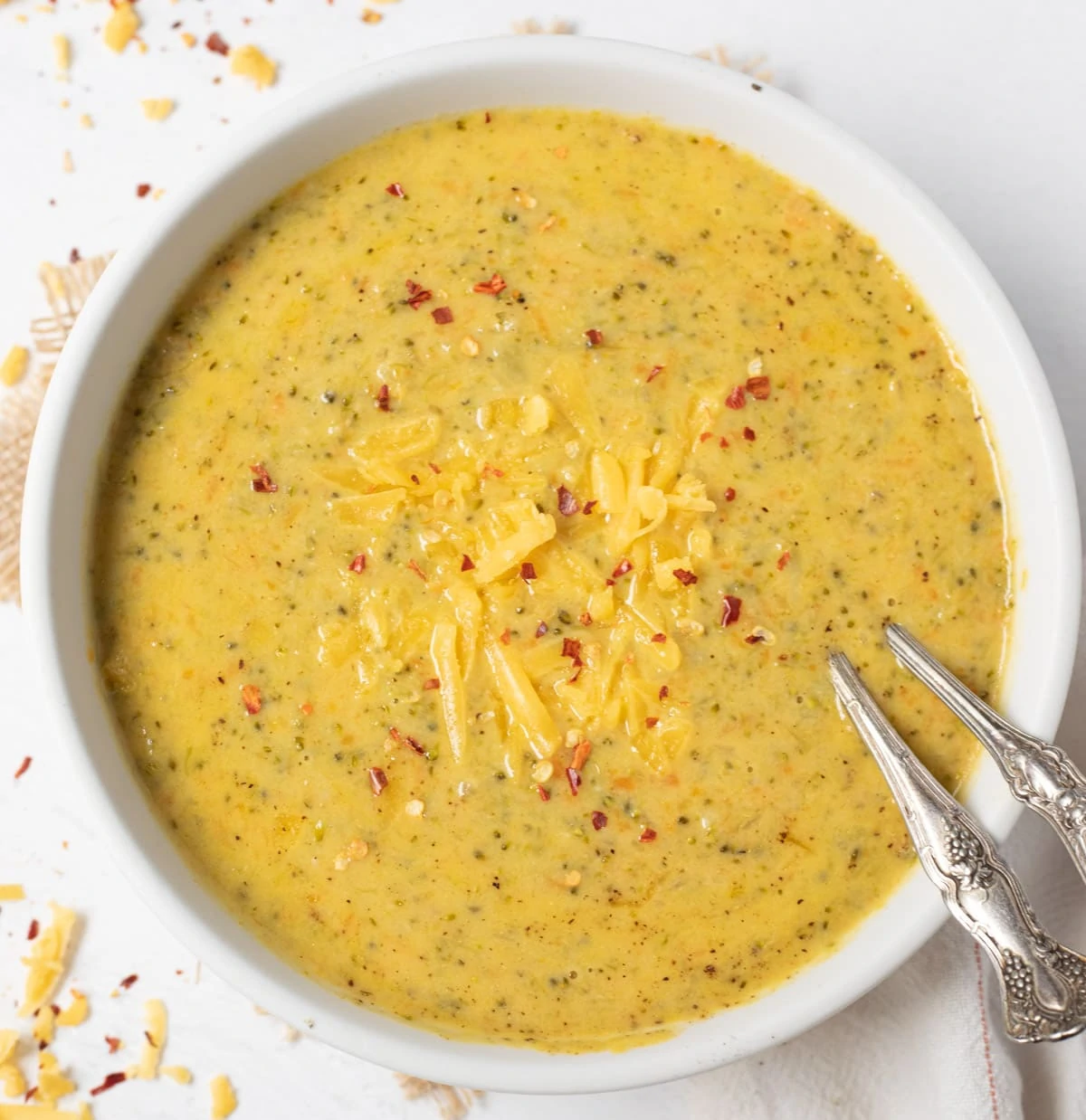 Broccoli Cheese Soup in a bowl topped with grated cheddar