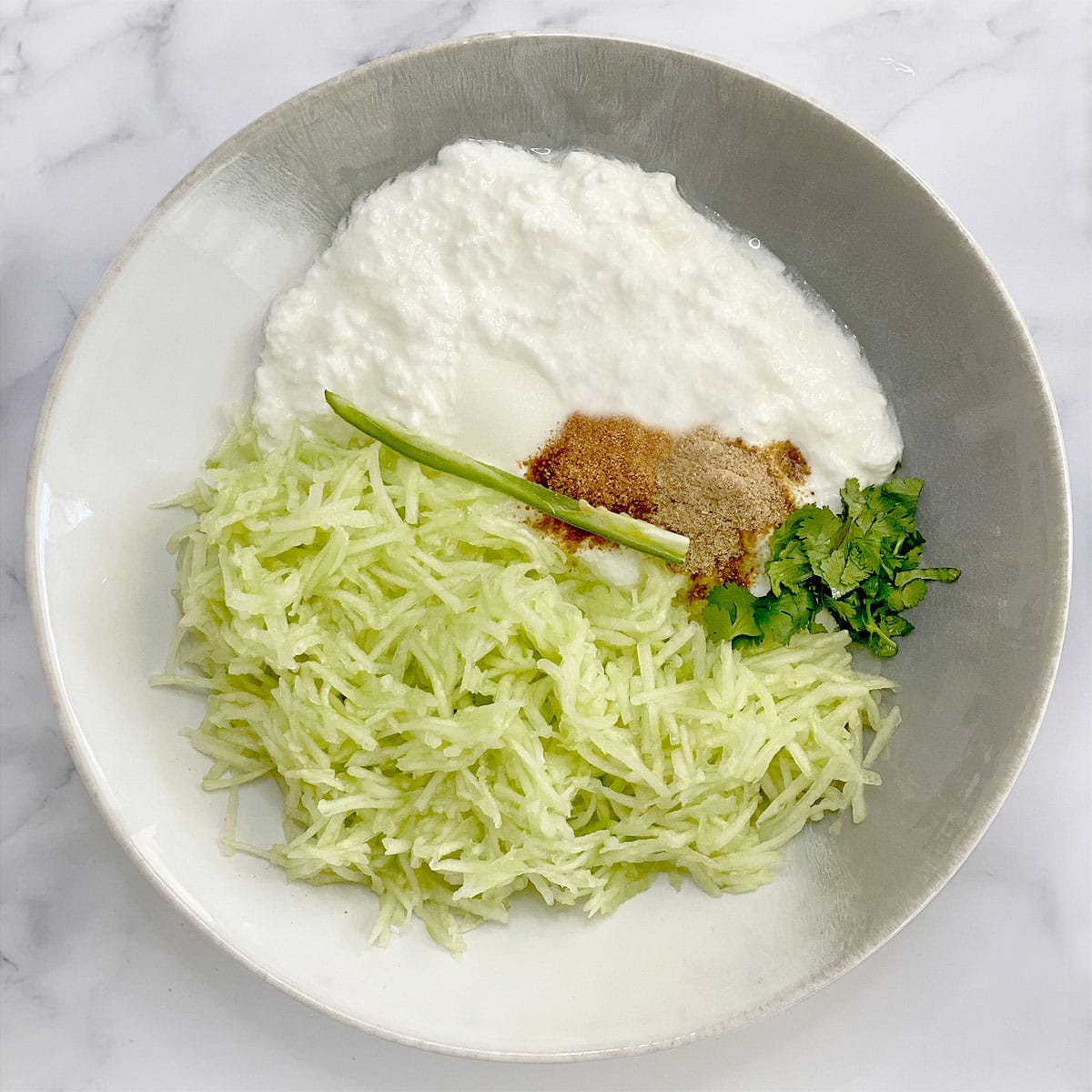 Mixing ingredients for cucumber raita