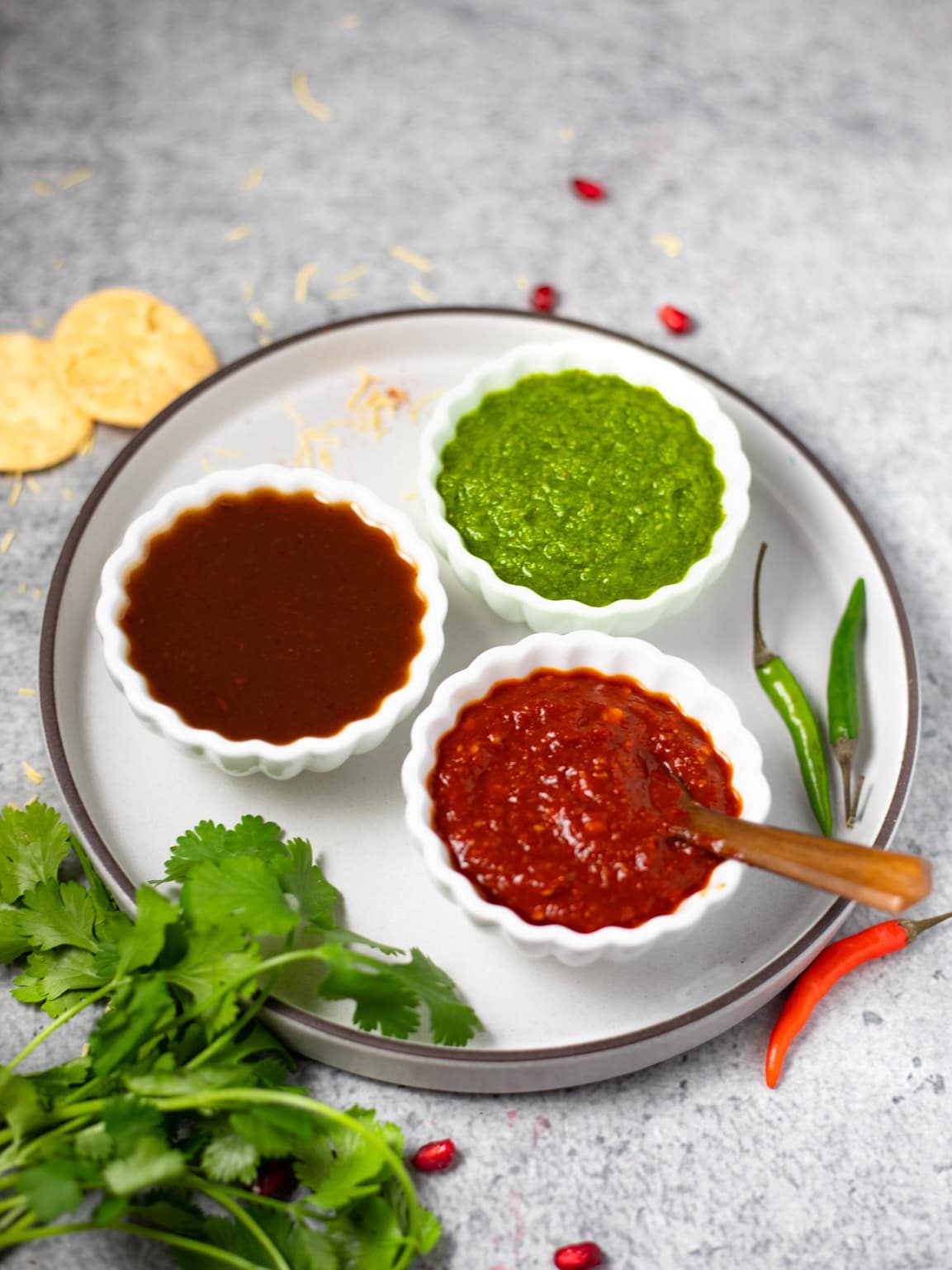 3 Indian chutney's in small white bowls 