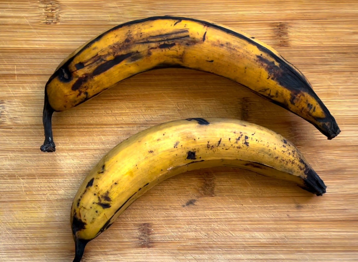 Two plantains on a cutting board