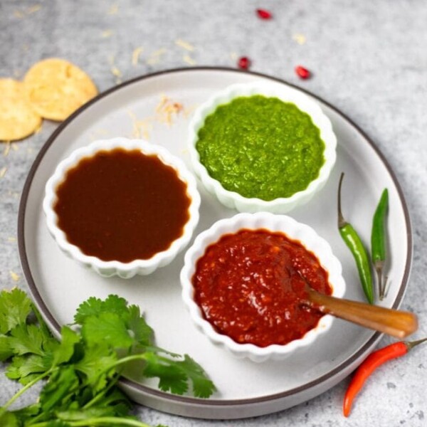 3 Indian chutney's in small white bowls