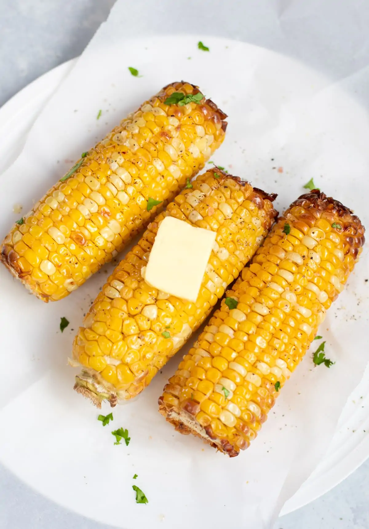 Grilled Corn on the Cobb topped with butter