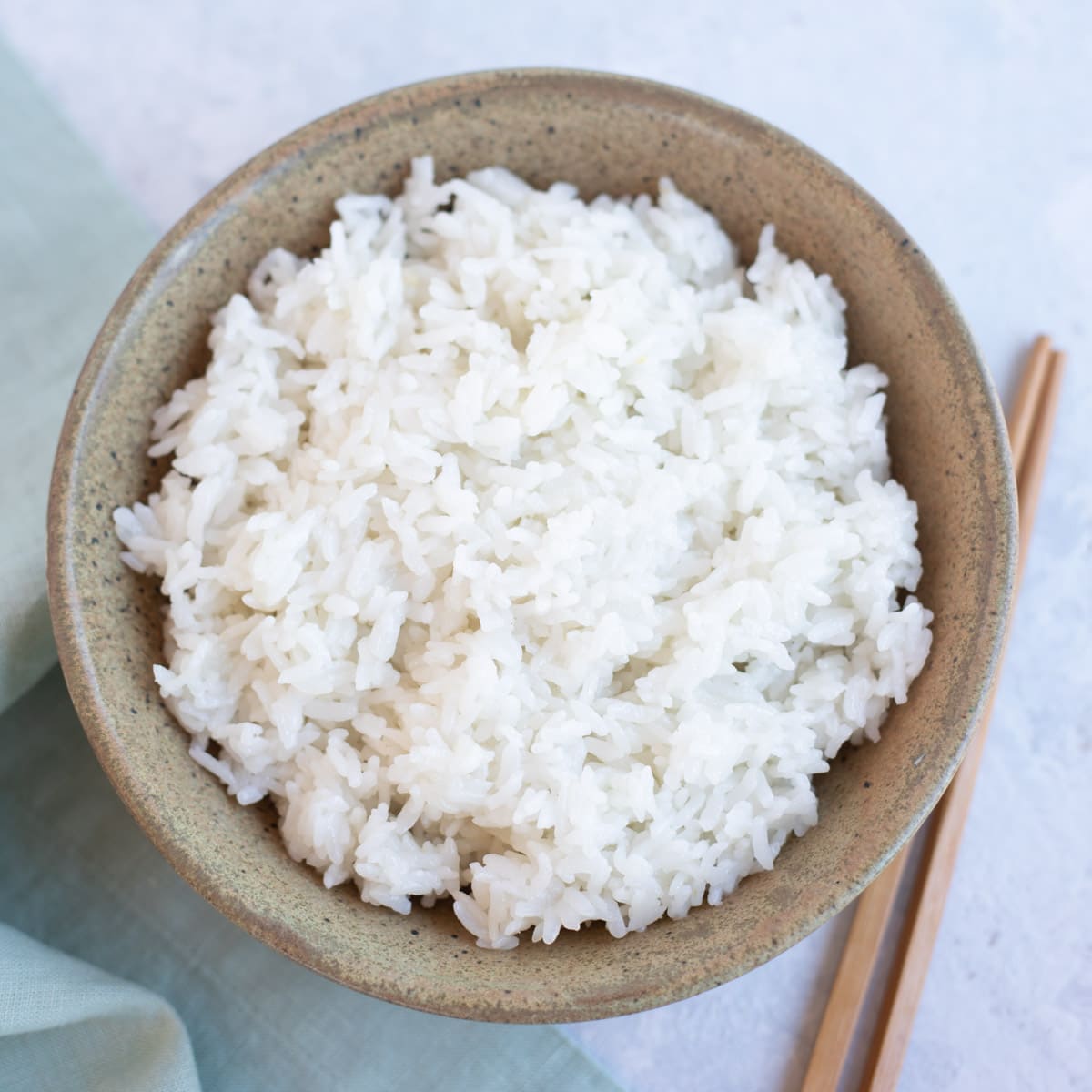 Calrose rice served in a bowl with chopsticks to eat
