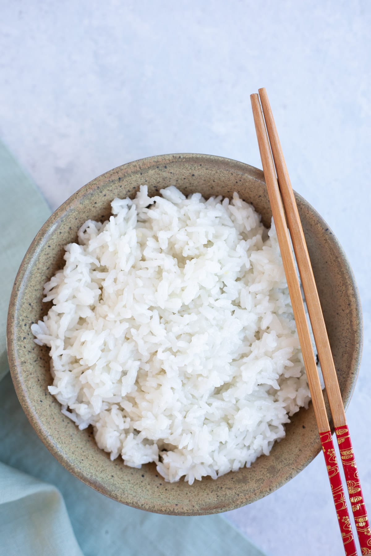 Calrose rice served in a bowl with chopsticks to eat