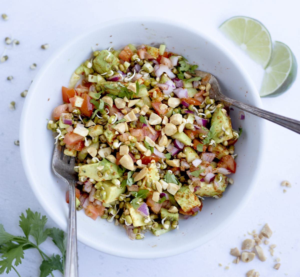 Easy sprouted mung bean salad in a bowl with lime, cilantro and nuts