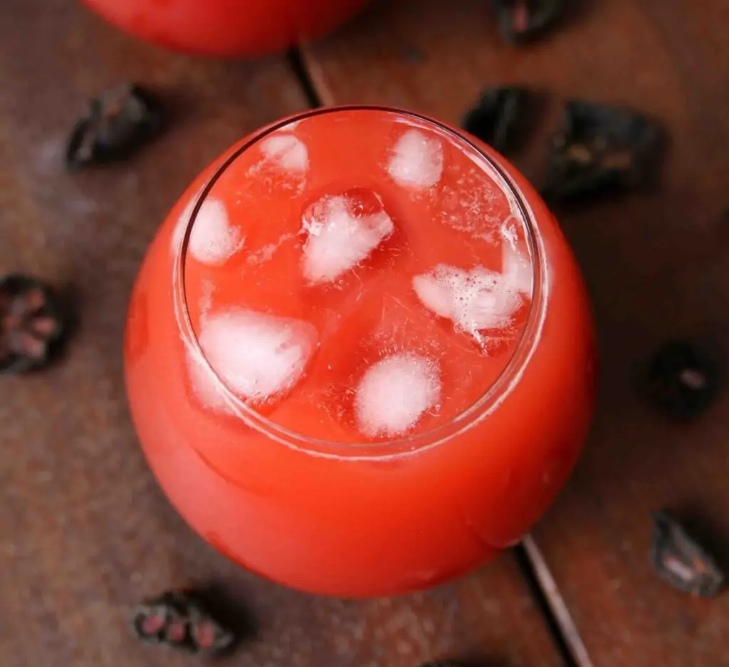 kokum juice in a glass topped with ice 