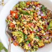 Protein sprouted beans salad in a bowl topped with chopped peanuts.