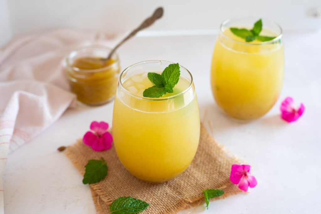 Delicious aam ka panna (tangy green mango drink) served in glasses topped with mint leaves