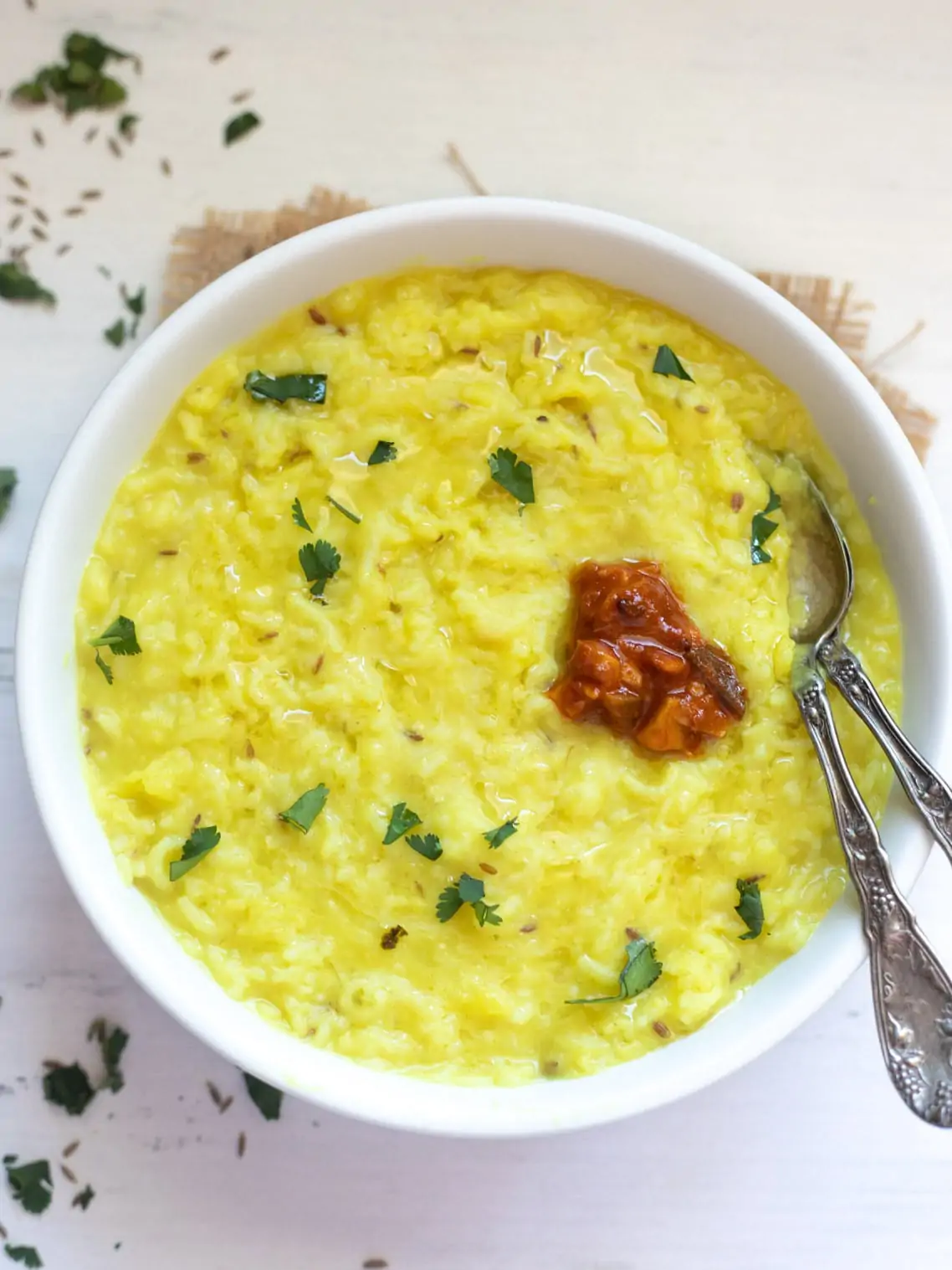 Khichdi in a bowl topped with pickle