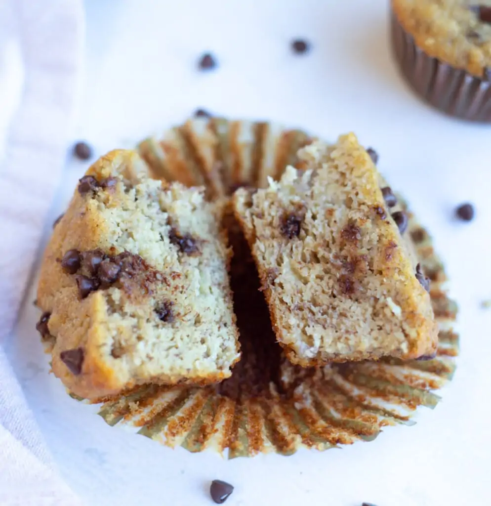 Soft Moist Banana Muffin with chocolate chips cut in two pieces. 